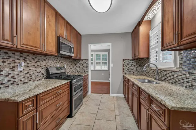 a stove top oven sitting inside of a kitchen