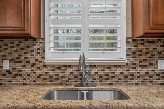 a kitchen with stainless steel appliances granite countertop a stove and a sink