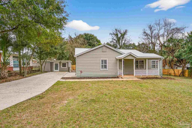 a front view of a house with a garden