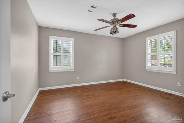 wooden floor in an empty room with a window