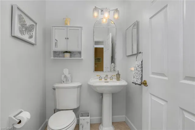 a bathroom with a sink mirror toilet and vanity