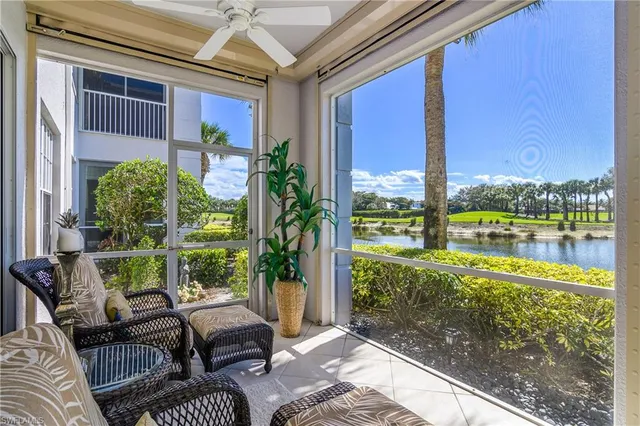 a balcony with furniture and a potted plant