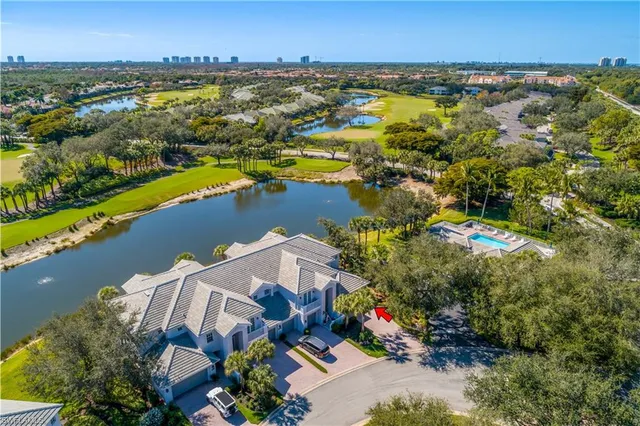 an aerial view of residential houses with outdoor space and swimming pool