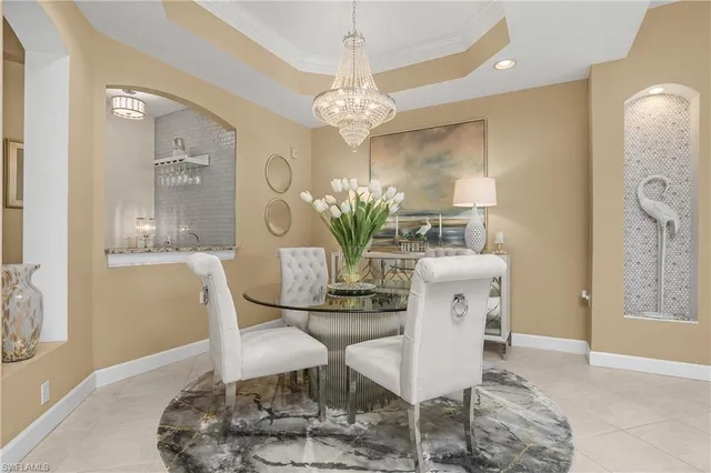 a dining room with furniture and chandelier