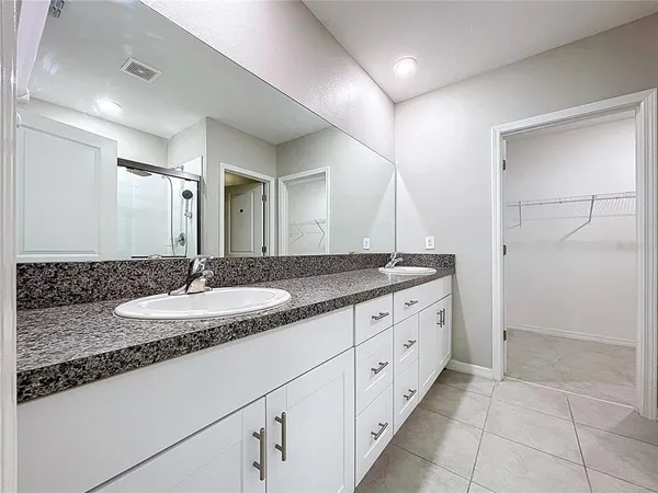an empty room with wooden floor ceiling fan and windows