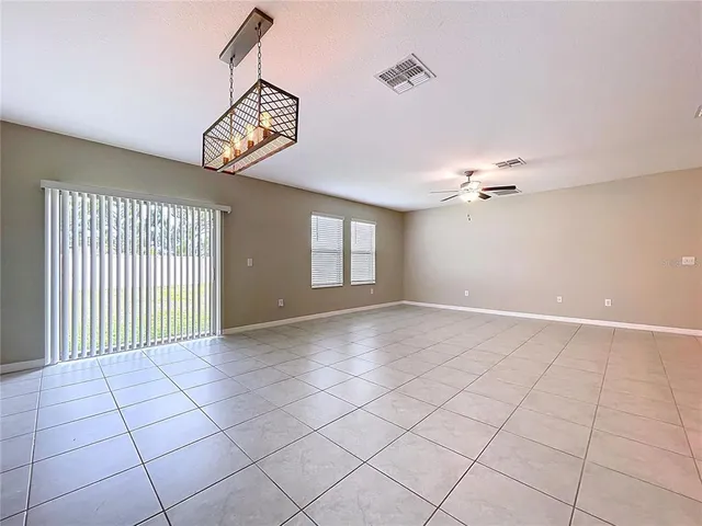 a kitchen with kitchen island granite countertop a sink and white cabinets
