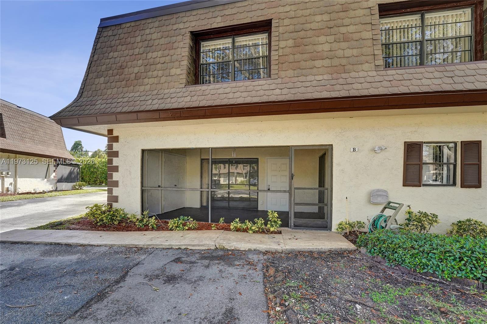 9340 Southwest 61st Way, Unit B Boca Raton, FL 33428 - Photo 20 of 25 a front view of a house