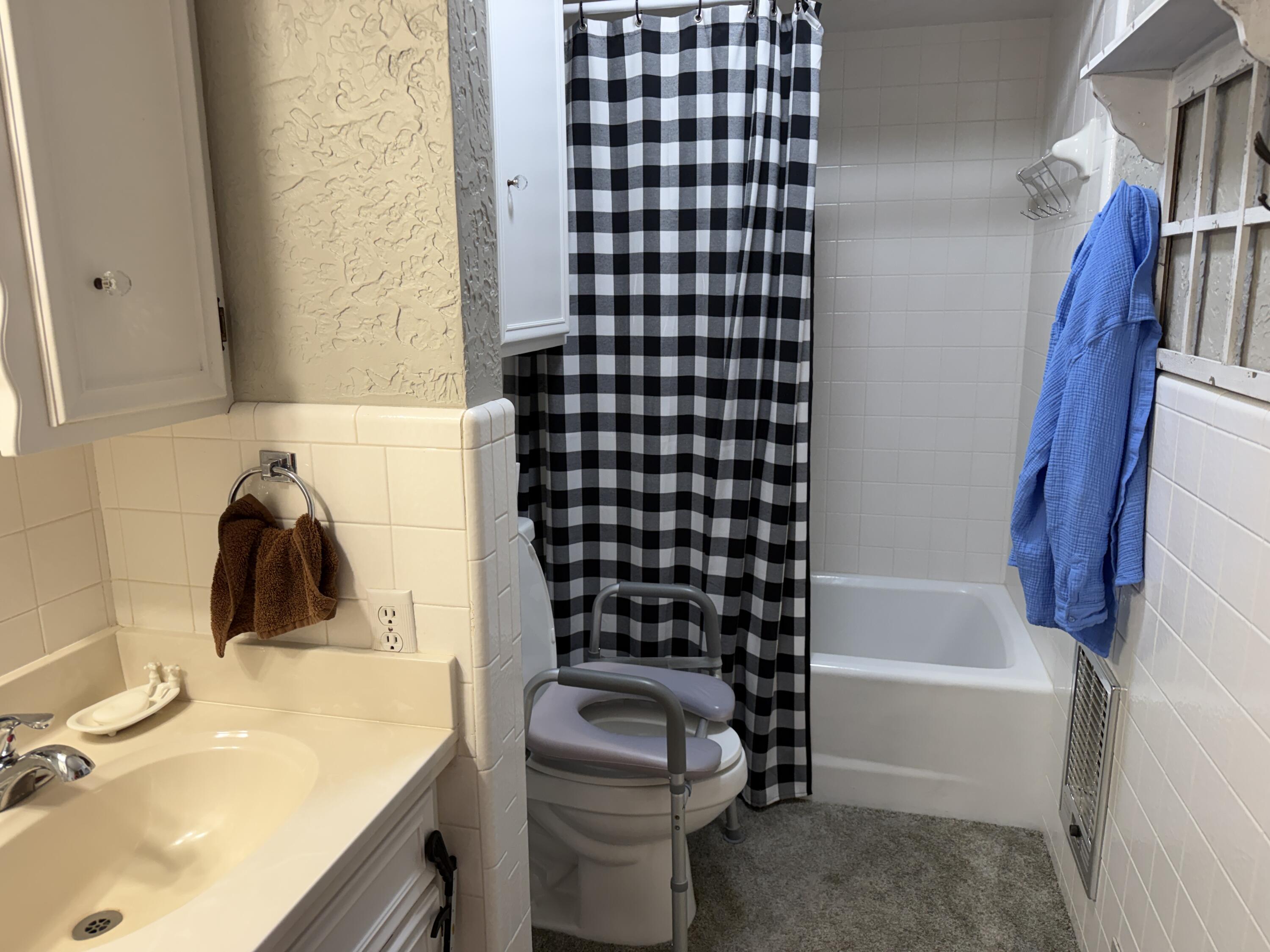 1603 South 8th Street Lamesa, TX 79331 - Photo 19 of 39 a bathroom with a sink toilet and shower