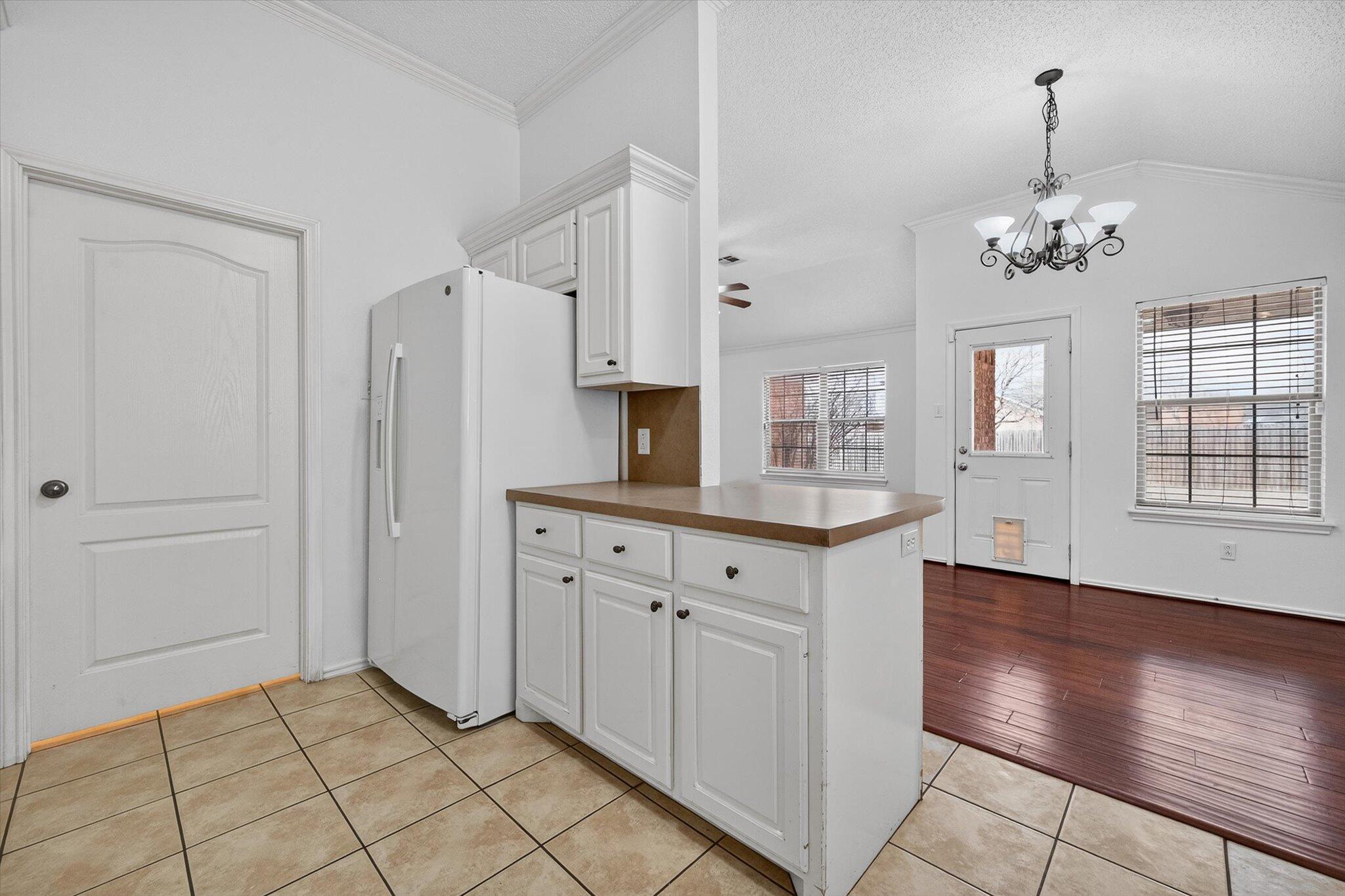 2216 97th Street Lubbock, TX 79423 - Photo 15 of 29 a view of a kitchen with dishwasher cabinet and a fireplace