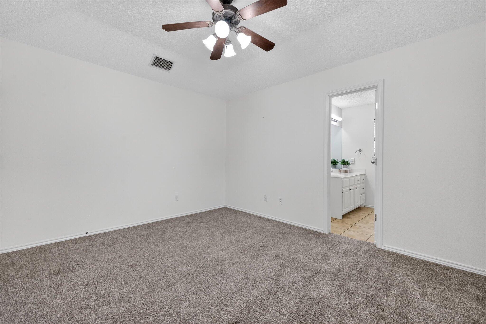 2216 97th Street Lubbock, TX 79423 - Photo 22 of 29 an empty room with closet and windows