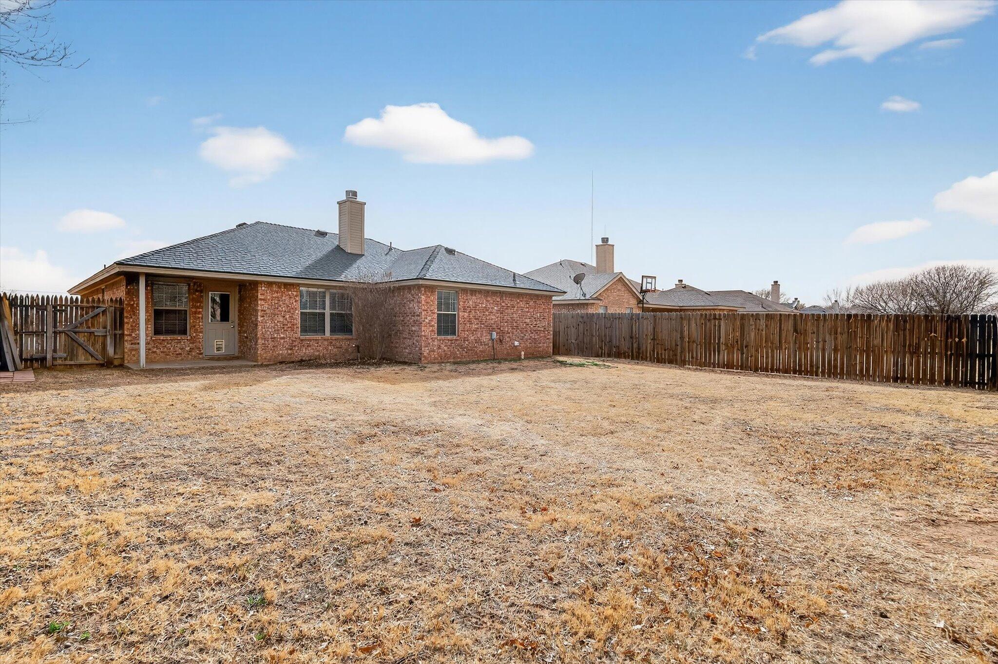 2216 97th Street Lubbock, TX 79423 - Photo 28 of 29 a front view of a house with a yard