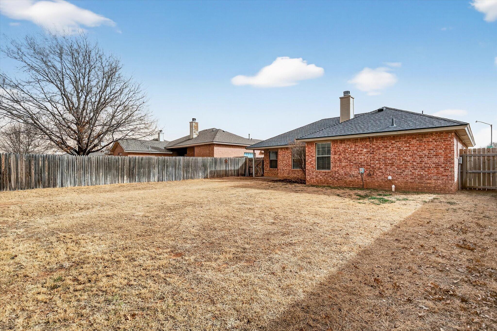 2216 97th Street Lubbock, TX 79423 - Photo 29 of 29 a front view of a house with a yard