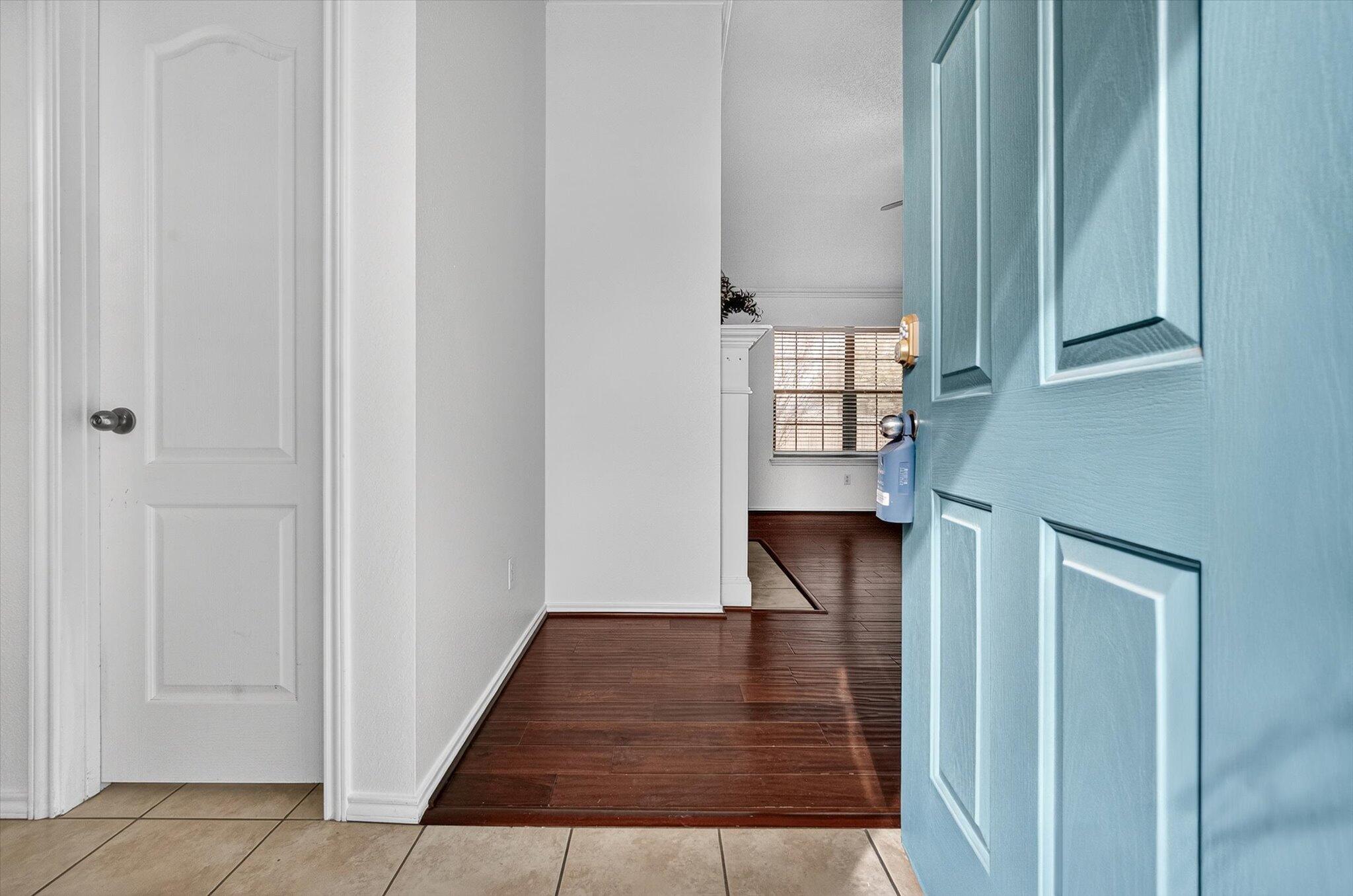 2216 97th Street Lubbock, TX 79423 - Photo 3 of 29 a view of a hallway with wooden floor and staircase