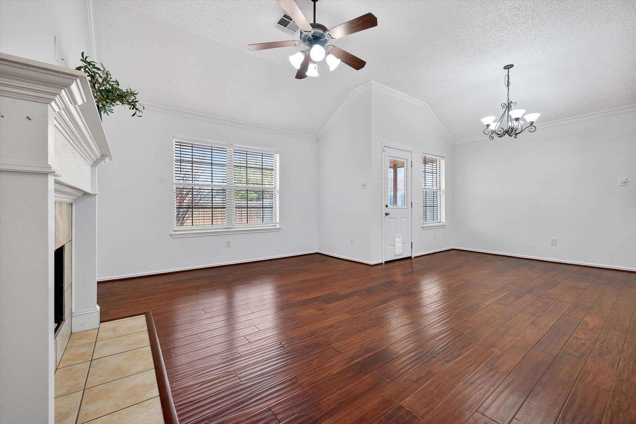 2216 97th Street Lubbock, TX 79423 - Photo 5 of 29 a view of an empty room with wooden floor and a window