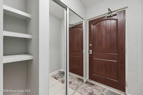 a spacious bedroom with a bed and a chandelier