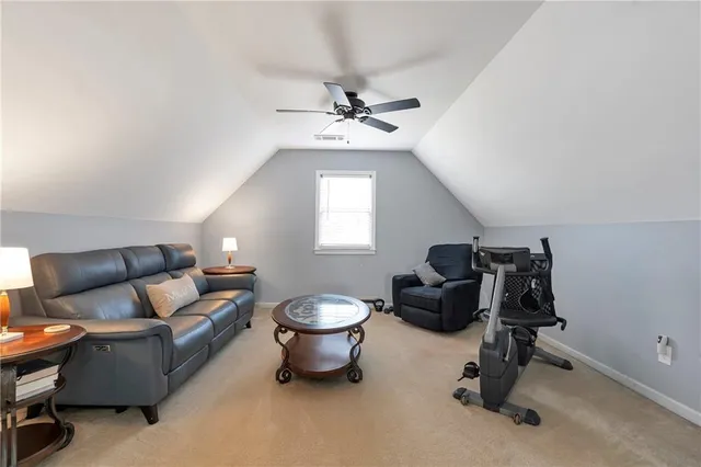 a living room with furniture a window and gym equipment