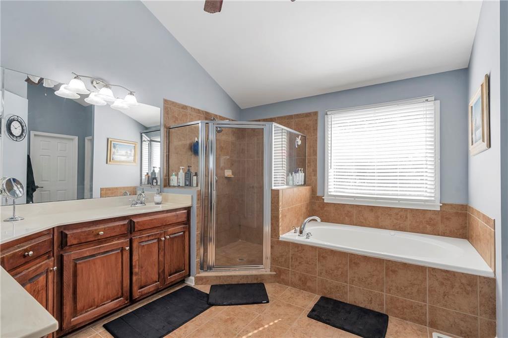 1224 Treemont Trace Winder, GA 30680 - Photo 12 of 27 a spacious bathroom with a tub sink shower and mirror
