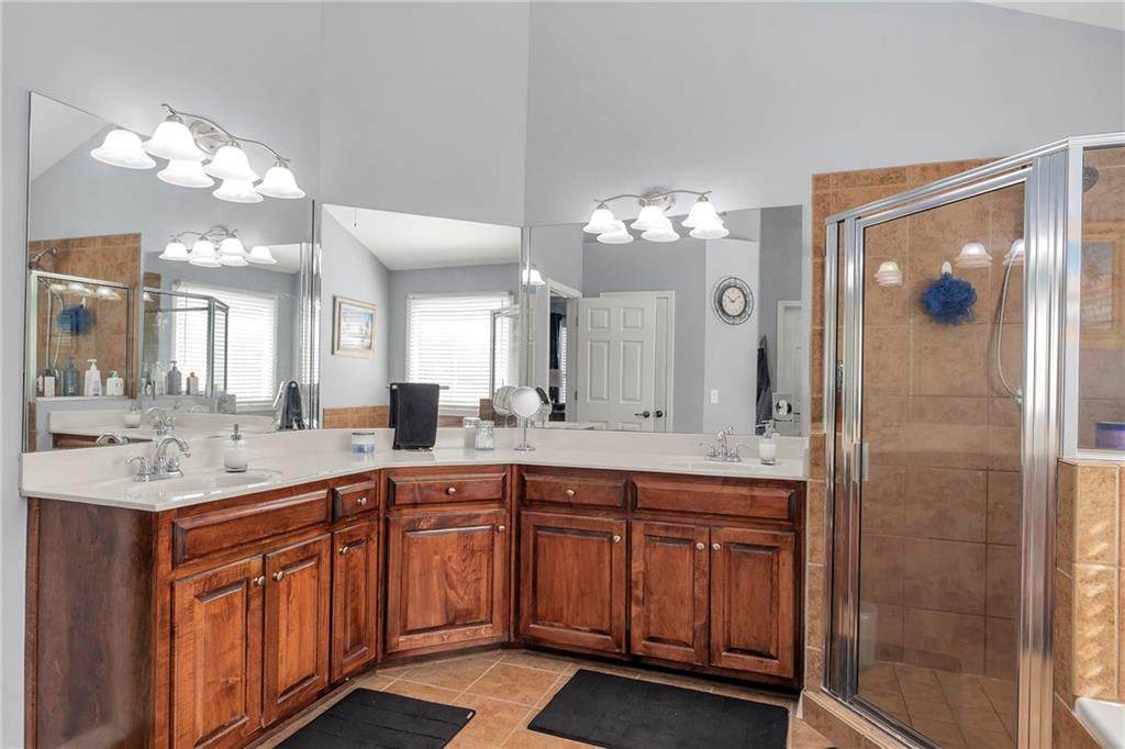 1224 Treemont Trace Winder, GA 30680 - Photo 13 of 27 a large bathroom with a sink a large mirror and a shower