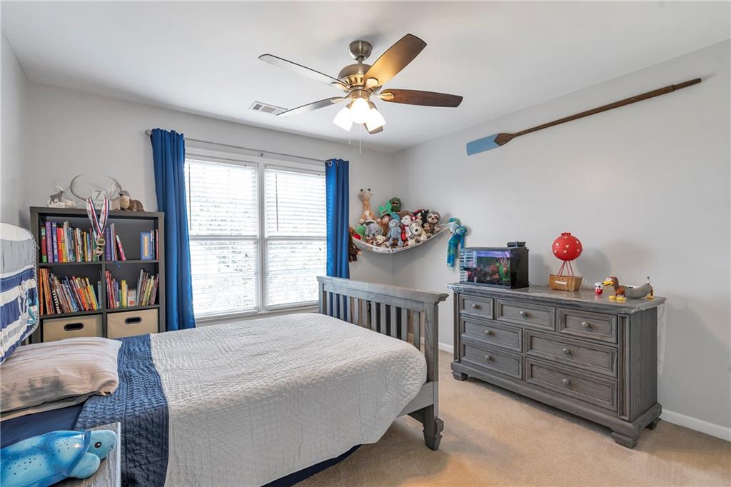 1224 Treemont Trace Winder, GA 30680 - Photo 14 of 27 a bedroom with a bed and a bookshelf