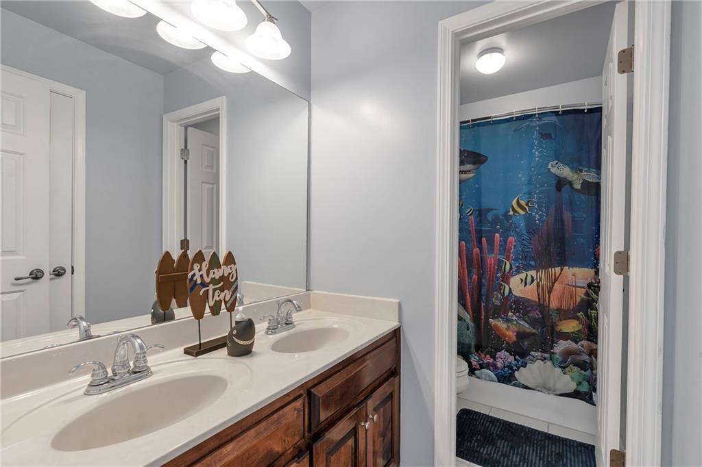 1224 Treemont Trace Winder, GA 30680 - Photo 17 of 27 a bathroom with a sink and a mirror