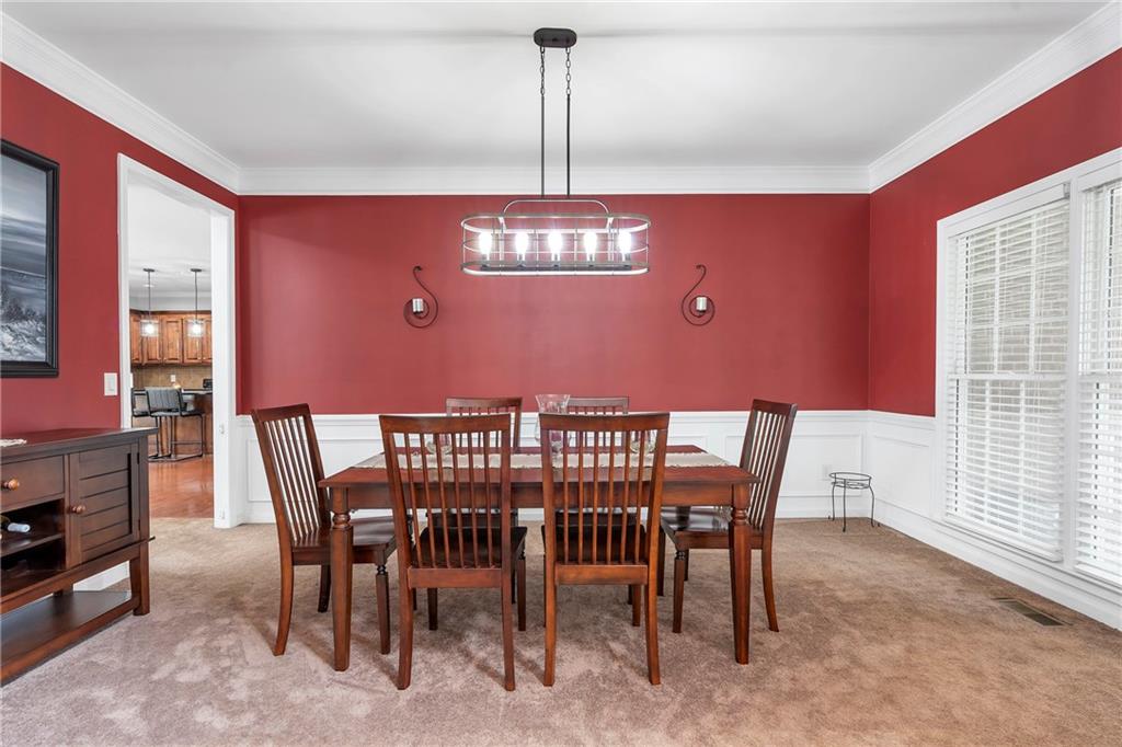 1224 Treemont Trace Winder, GA 30680 - Photo 5 of 27 a view of a dining room with furniture and chandelier