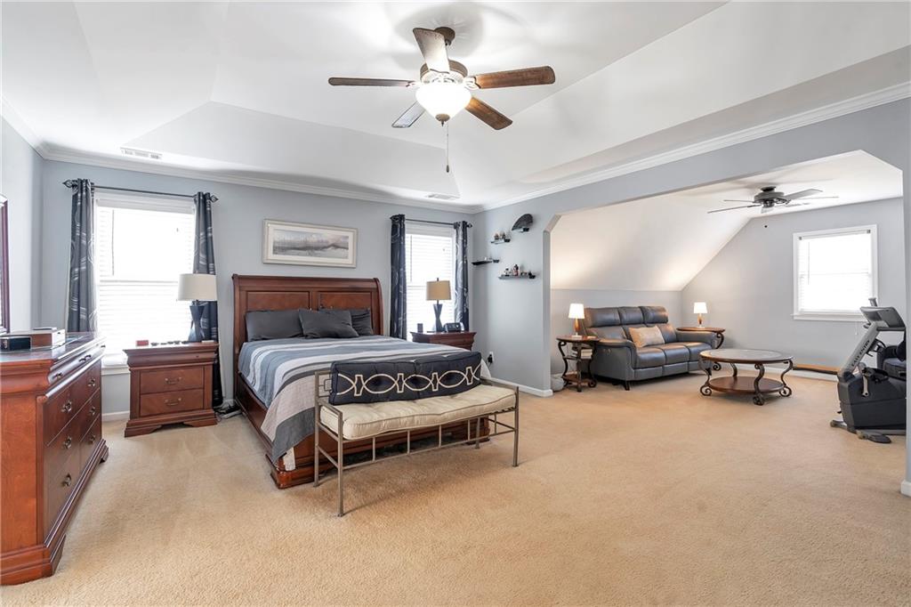 1224 Treemont Trace Winder, GA 30680 - Photo 9 of 27 a bedroom with furniture and a chandelier