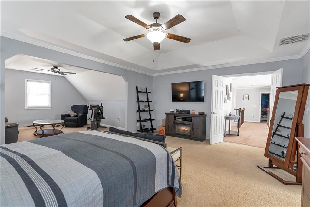 1224 Treemont Trace Winder, GA 30680 - Photo 10 of 27 a bedroom with bed tv and a large mirror