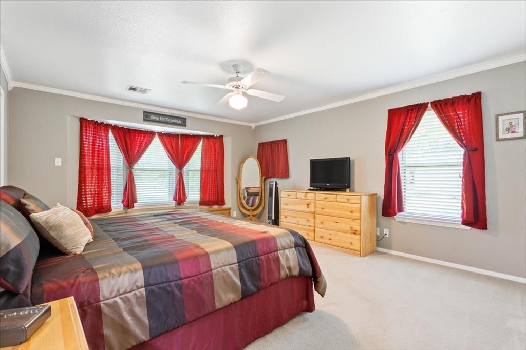 109 Hilltop Street Riesel, TX 76682 - Photo 16 of 32 a bedroom with a bed and a flat screen tv