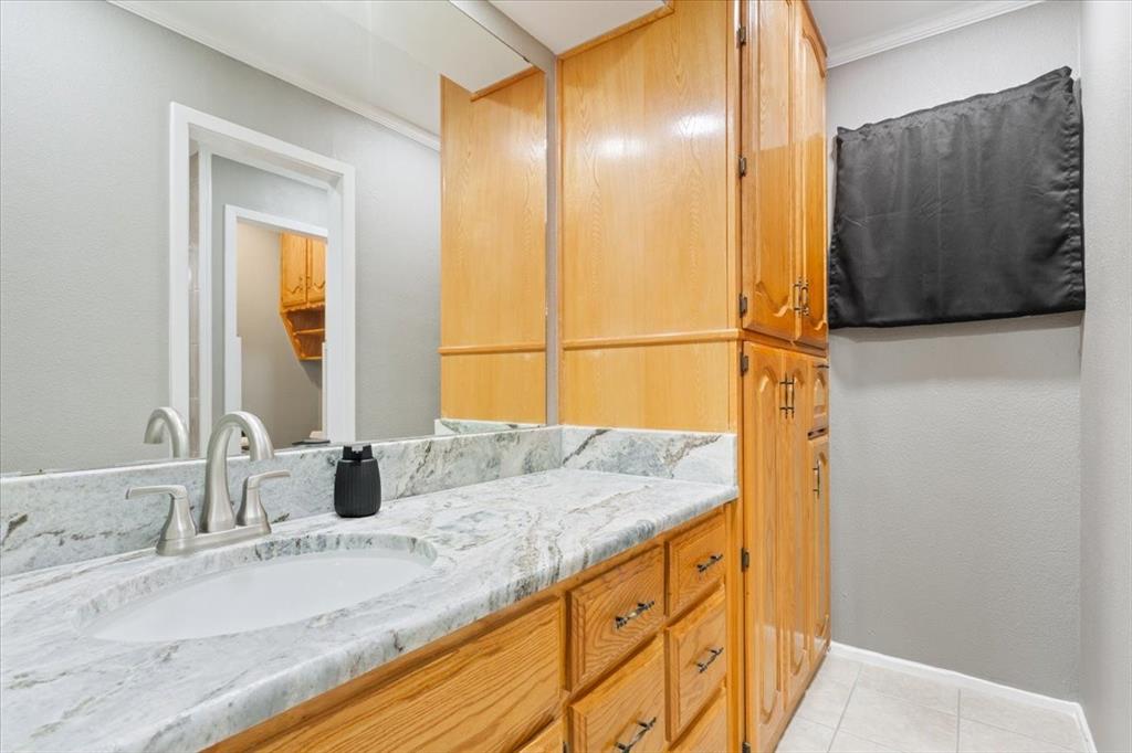 109 Hilltop Street Riesel, TX 76682 - Photo 18 of 32 a bathroom with a granite countertop sink and a mirror