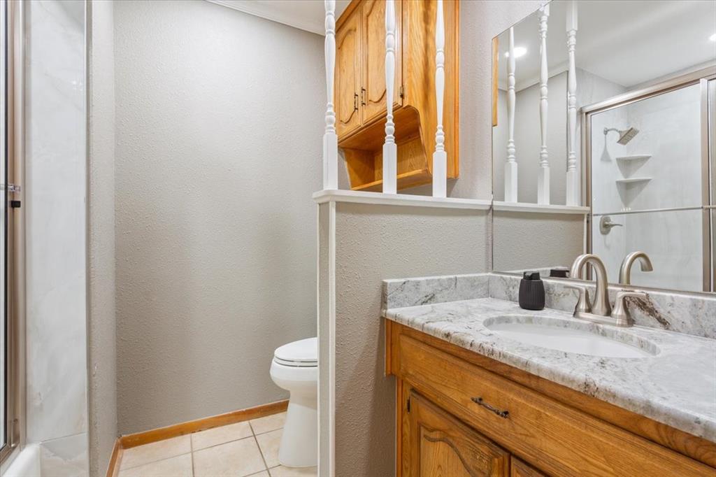 109 Hilltop Street Riesel, TX 76682 - Photo 21 of 32 a bathroom with a granite countertop sink and a mirror