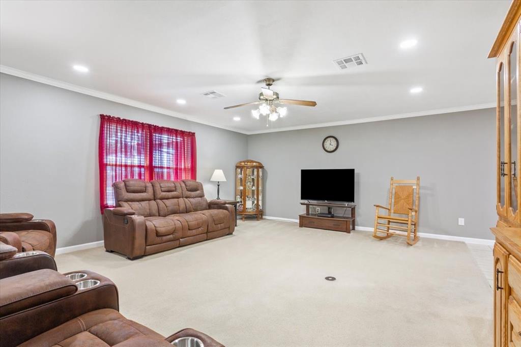 109 Hilltop Street Riesel, TX 76682 - Photo 8 of 32 a living room with furniture and a flat screen tv