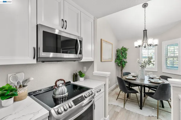 a kitchen with a sink a microwave and cabinets
