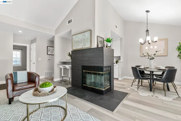 a living room with furniture a table and a fireplace