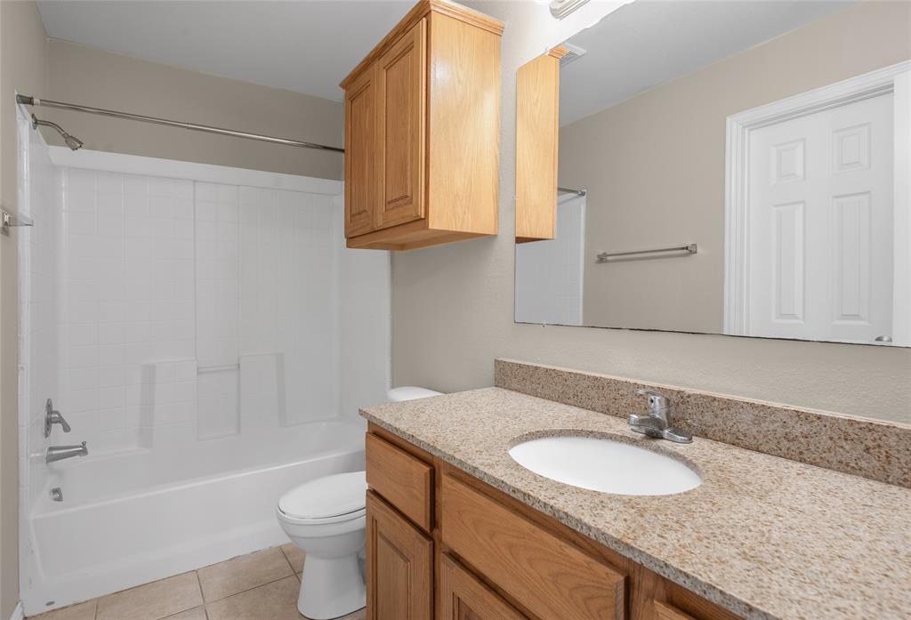 1001 Krenek Tap Road, Unit 801 College Station, TX 77840 - Photo 12 of 21 a bathroom with a granite countertop sink toilet and shower