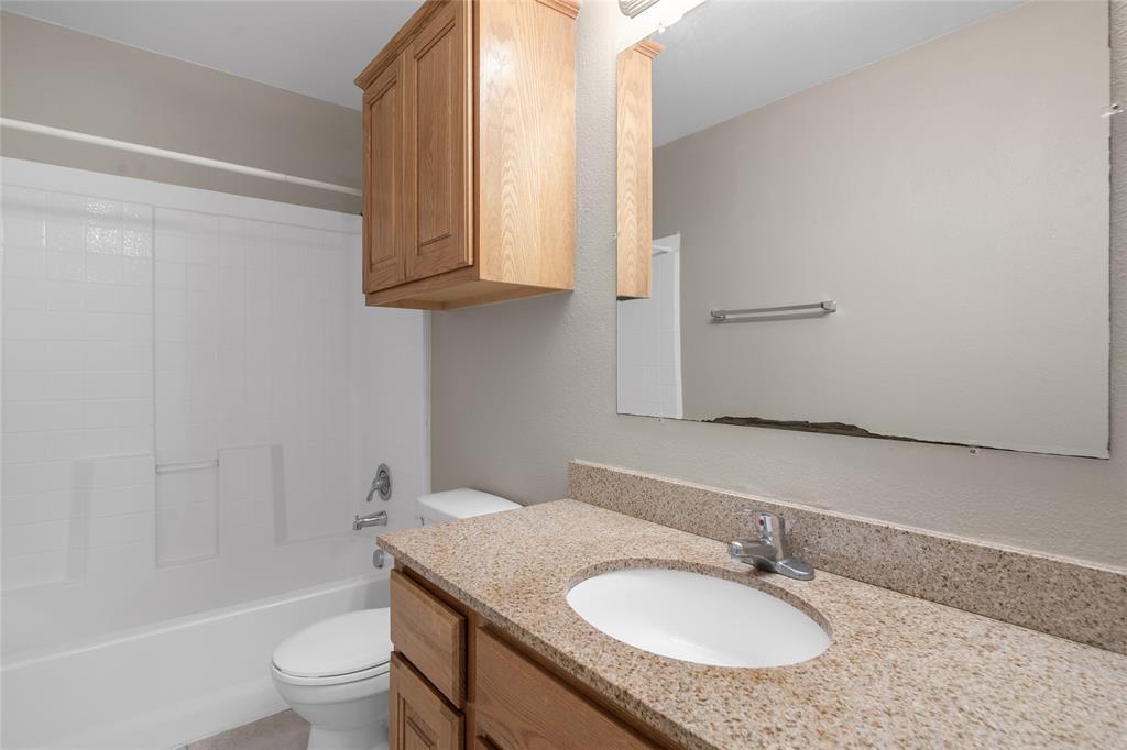 1001 Krenek Tap Road, Unit 801 College Station, TX 77840 - Photo 17 of 21 a bathroom with a granite countertop sink toilet and shower