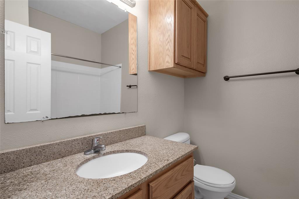1001 Krenek Tap Road, Unit 801 College Station, TX 77840 - Photo 19 of 21 a bathroom with a granite countertop toilet sink and mirror