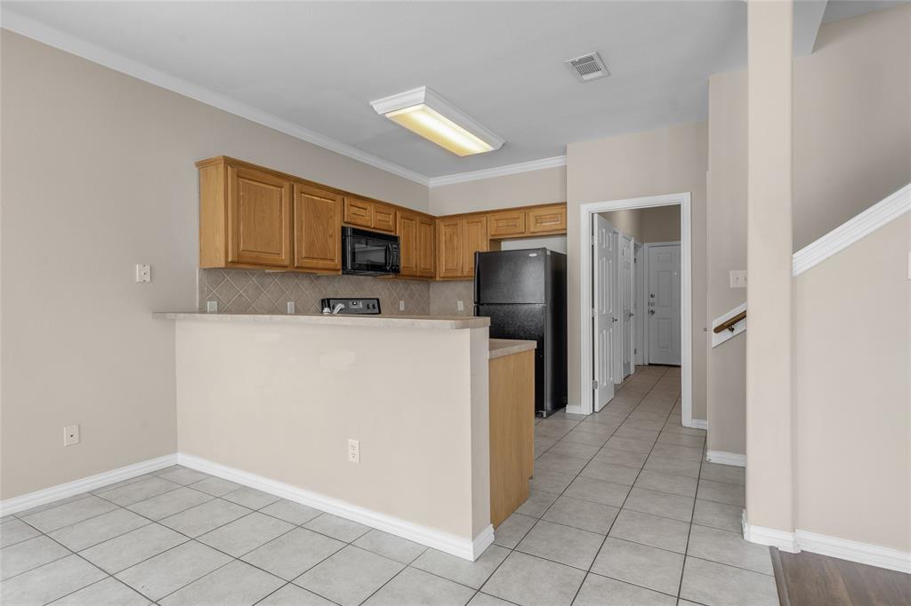 1001 Krenek Tap Road, Unit 801 College Station, TX 77840 - Photo 7 of 21 a kitchen with a refrigerator a microwave and a sink