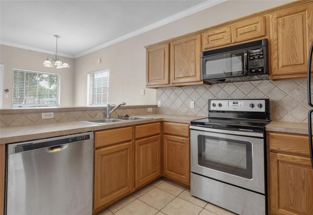 1001 Krenek Tap Road, Unit 801 College Station, TX 77840 - Photo 8 of 21 a kitchen with granite countertop cabinets stainless steel appliances and a sink