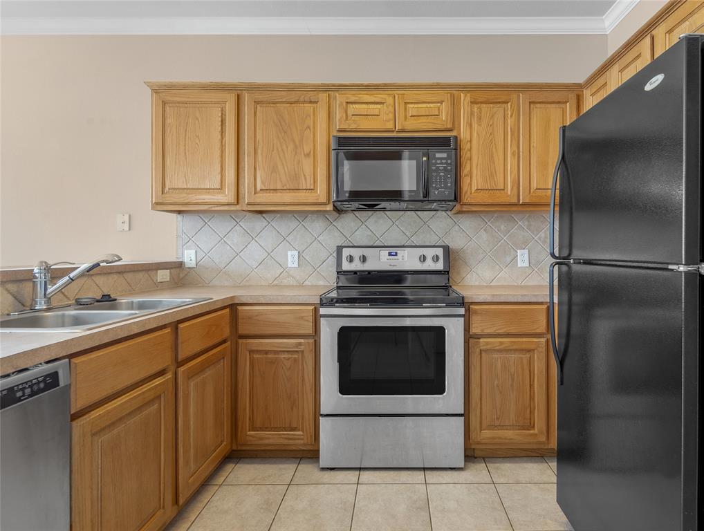 1001 Krenek Tap Road, Unit 801 College Station, TX 77840 - Photo 9 of 21 a kitchen with cabinets stainless steel appliances and a sink