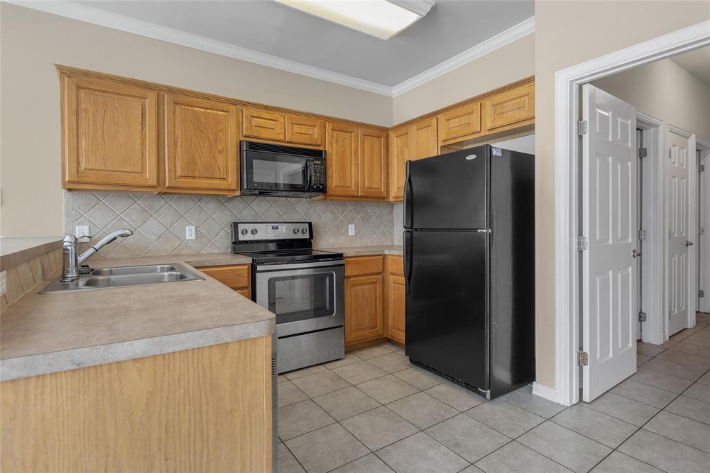1001 Krenek Tap Road, Unit 801 College Station, TX 77840 - Photo 10 of 21 a kitchen with a refrigerator sink and cabinets