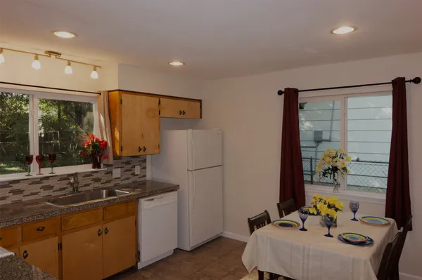 a kitchen with stainless steel appliances a sink and a refrigerator
