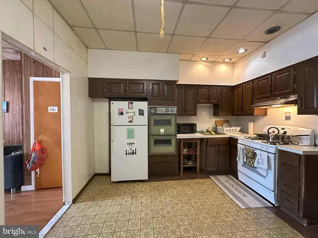 a kitchen with stainless steel appliances granite countertop a stove refrigerator sink and cabinets