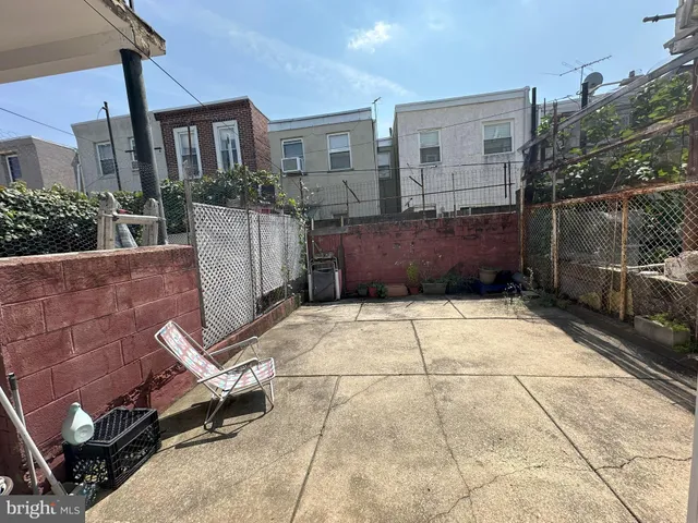a view of a patio with table and chairs and potted plants
