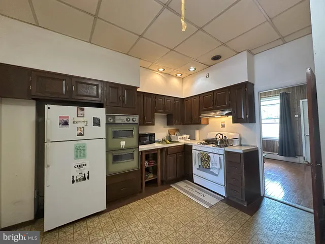 a kitchen with stainless steel appliances granite countertop a refrigerator and a stove