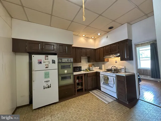 a kitchen with stainless steel appliances granite countertop a stove refrigerator sink and dishwasher
