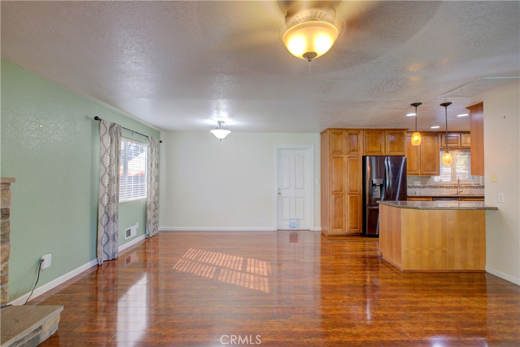 3728 Fuchsia Lane Modesto, CA 95356 - Photo 12 of 47 a view of empty room with wooden floor and fan