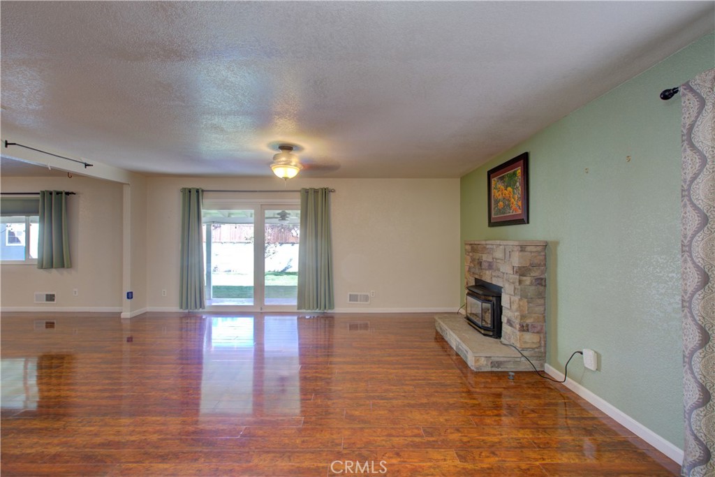 3728 Fuchsia Lane Modesto, CA 95356 - Photo 13 of 47 a view of an empty room with a fireplace and a window