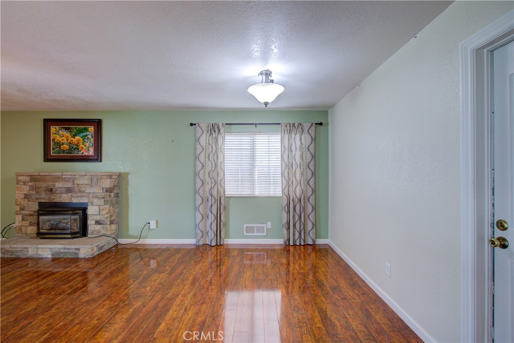 3728 Fuchsia Lane Modesto, CA 95356 - Photo 14 of 47 a view of empty room with wooden floor and fireplace