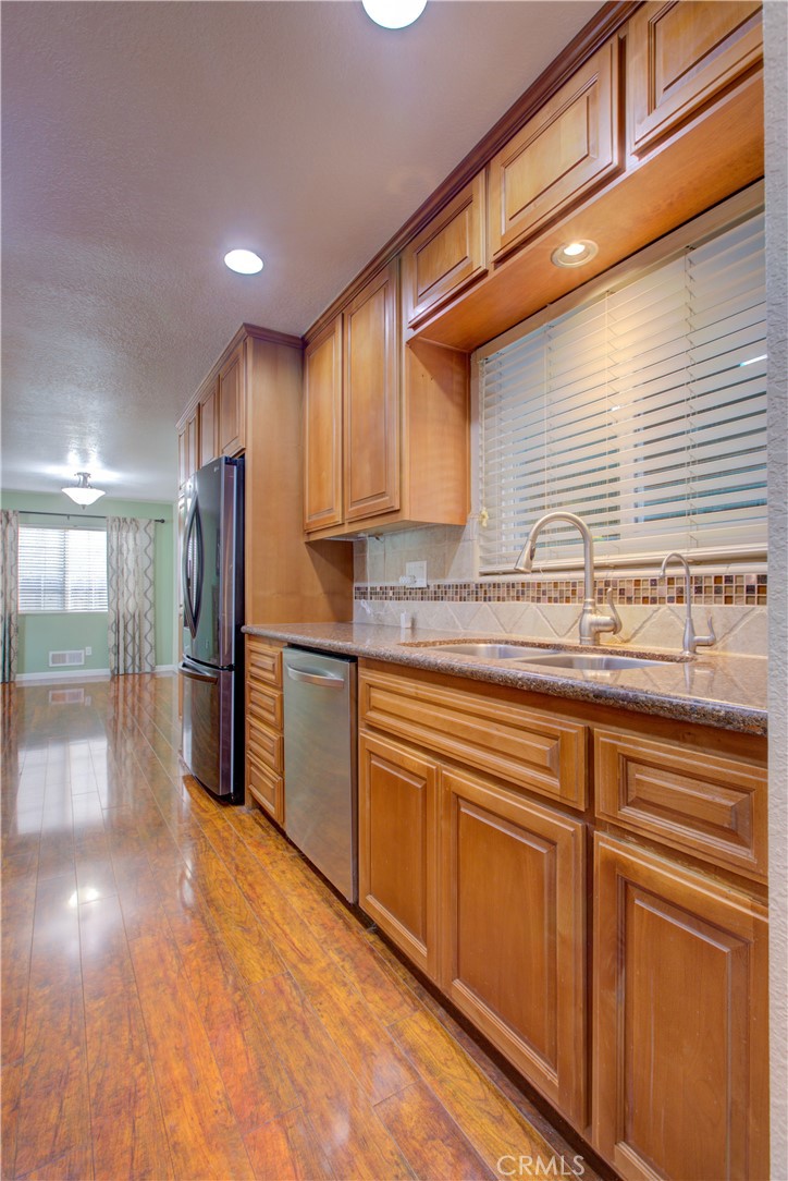 3728 Fuchsia Lane Modesto, CA 95356 - Photo 18 of 47 a kitchen with stainless steel appliances granite countertop a sink a stove and a refrigerator