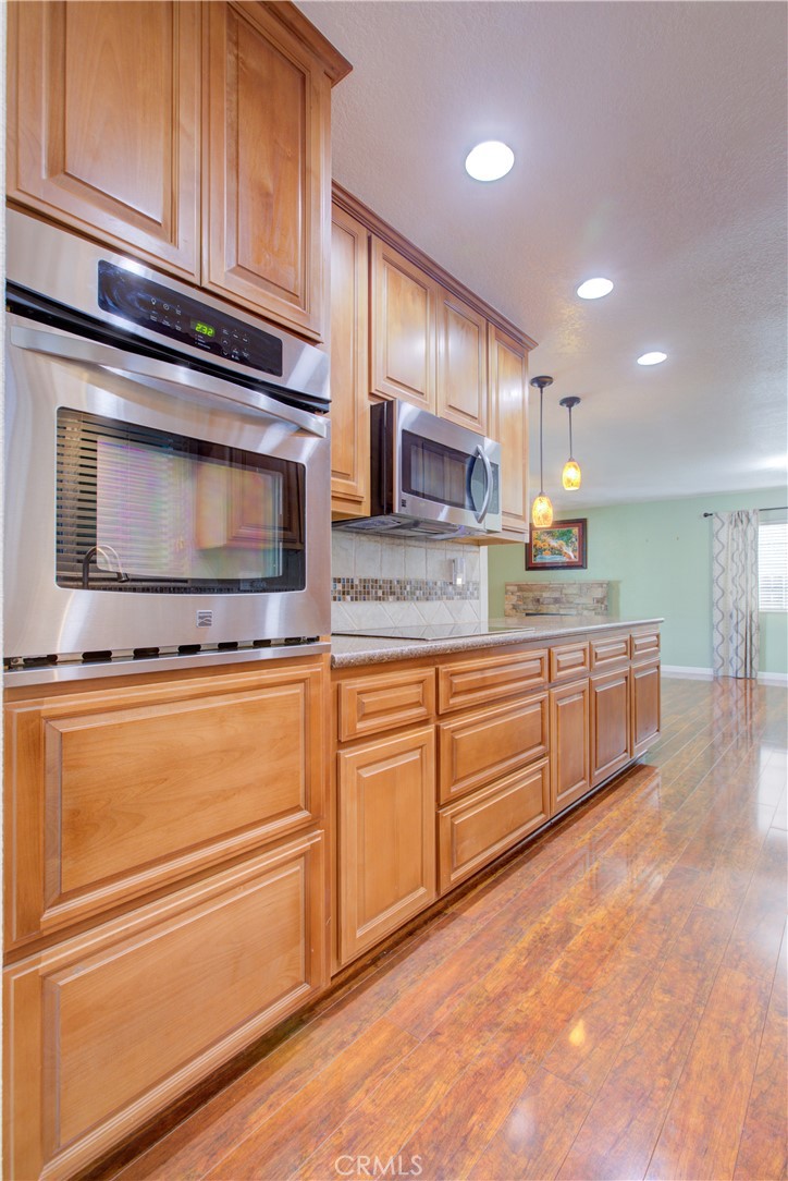 3728 Fuchsia Lane Modesto, CA 95356 - Photo 19 of 47 a kitchen with stainless steel appliances granite countertop a sink stove and microwave